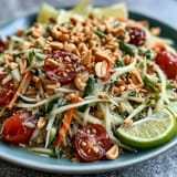 Colorful Som Tam salad, a refreshing Thai dish with crunchy peanuts and lime.
