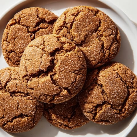 Golden-brown soft ginger cookies, fresh from the oven, offering a delightful chewy texture.