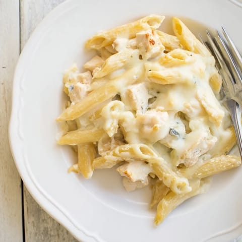 A comforting Chicken Alfredo Casserole with creamy sauce, tender chicken, and penne pasta, perfect for a family dinner.