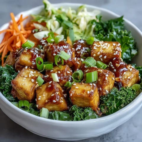 Colorful tofu egg roll in a bowl with crispy tofu, sautéed cabbage, kale, spinach, and carrot in a savory sesame-soy sauce.
