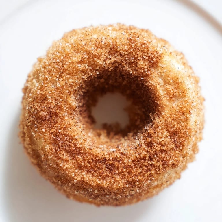 A close-up of freshly baked apple cider donuts, showcasing their tender crumb and delicious flavor.