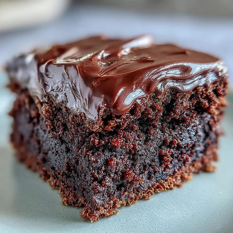 Frosted Easy Chocolate Fudge Cake layers topped with fresh raspberries and mint.