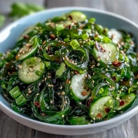 Vibrant Seaweed Salad with crisp cucumber and zesty sesame-ginger dressing, easy appetizer.