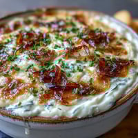 Golden, bubbly Smoked Gouda & Onion Dip fresh from the oven, topped with fresh green chives.