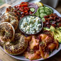 Spring Brunch Smoked Salmon Bagel Board with Cream Cheese, artfully arranged with smoked salmon slices, fresh bagels, and vibrant garnishes for a picture-perfect brunch spread.